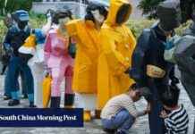 Sculpture of Yellow Raincoats in Hong Kong Cultural Centre sculpture-of-yellow-raincoats-in-hong-kong-cultural-centre