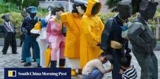 Sculpture of Yellow Raincoats in Hong Kong Cultural Centre sculpture-of-yellow-raincoats-in-hong-kong-cultural-centre