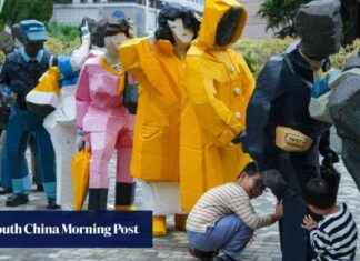 Sculpture of Yellow Raincoats in Hong Kong Cultural Centre sculpture-of-yellow-raincoats-in-hong-kong-cultural-centre